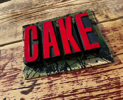 “CAKE” artwork from reclaimed Printing blocks
