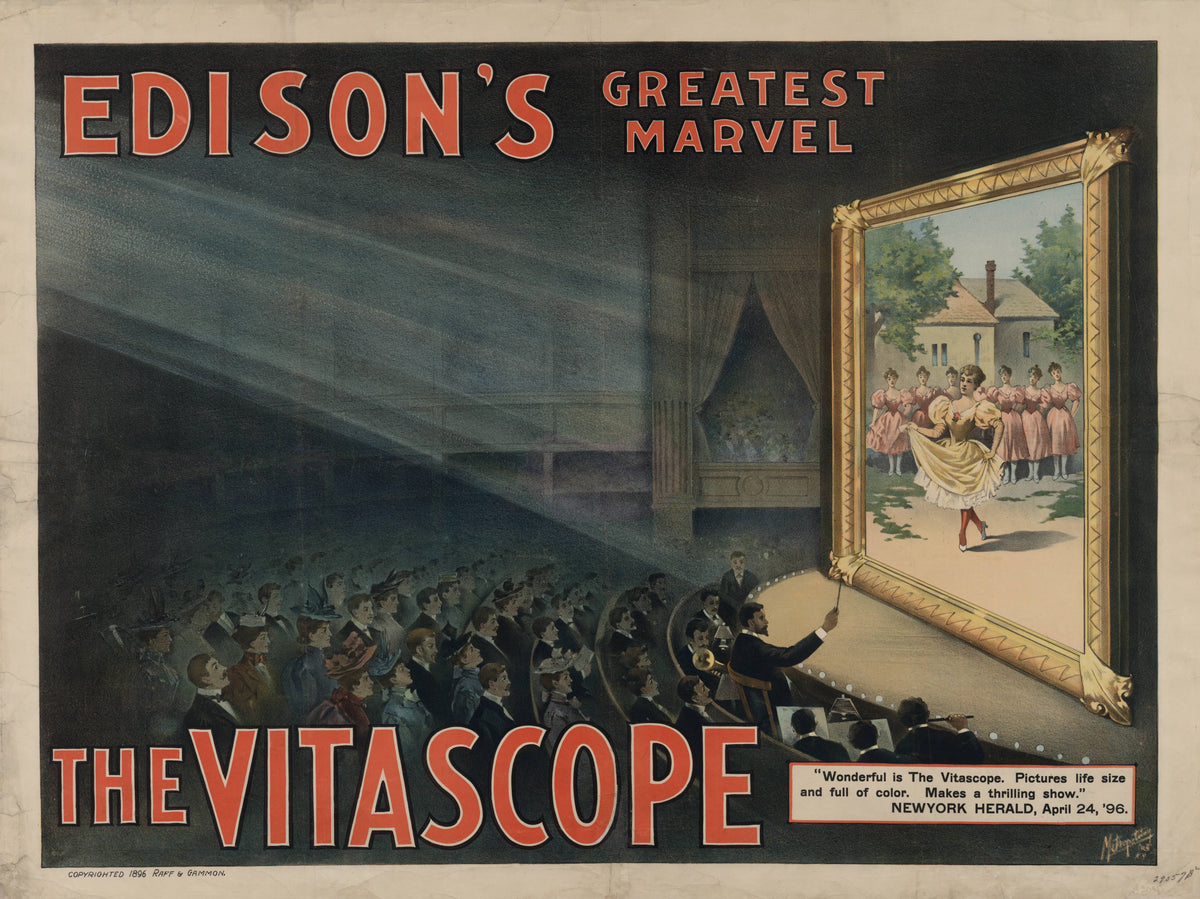 A cinema audience watches dancers projected onto a large framed screen beneath bold red lettering for Edison's Vitascope.