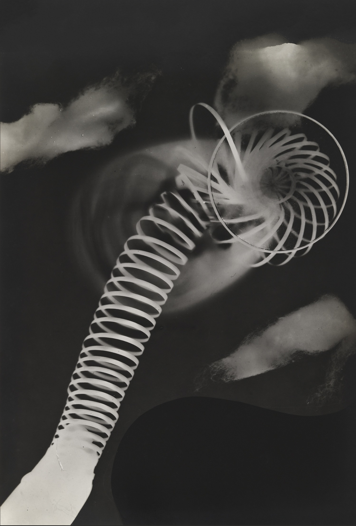A bright coiled spring sweeps diagonally through the composition, ending in circular loops among soft hand-like silhouettes.