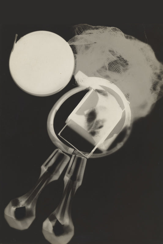 A pale disc, translucent mesh and a circular frame overlap above elongated glass-like silhouettes against black.