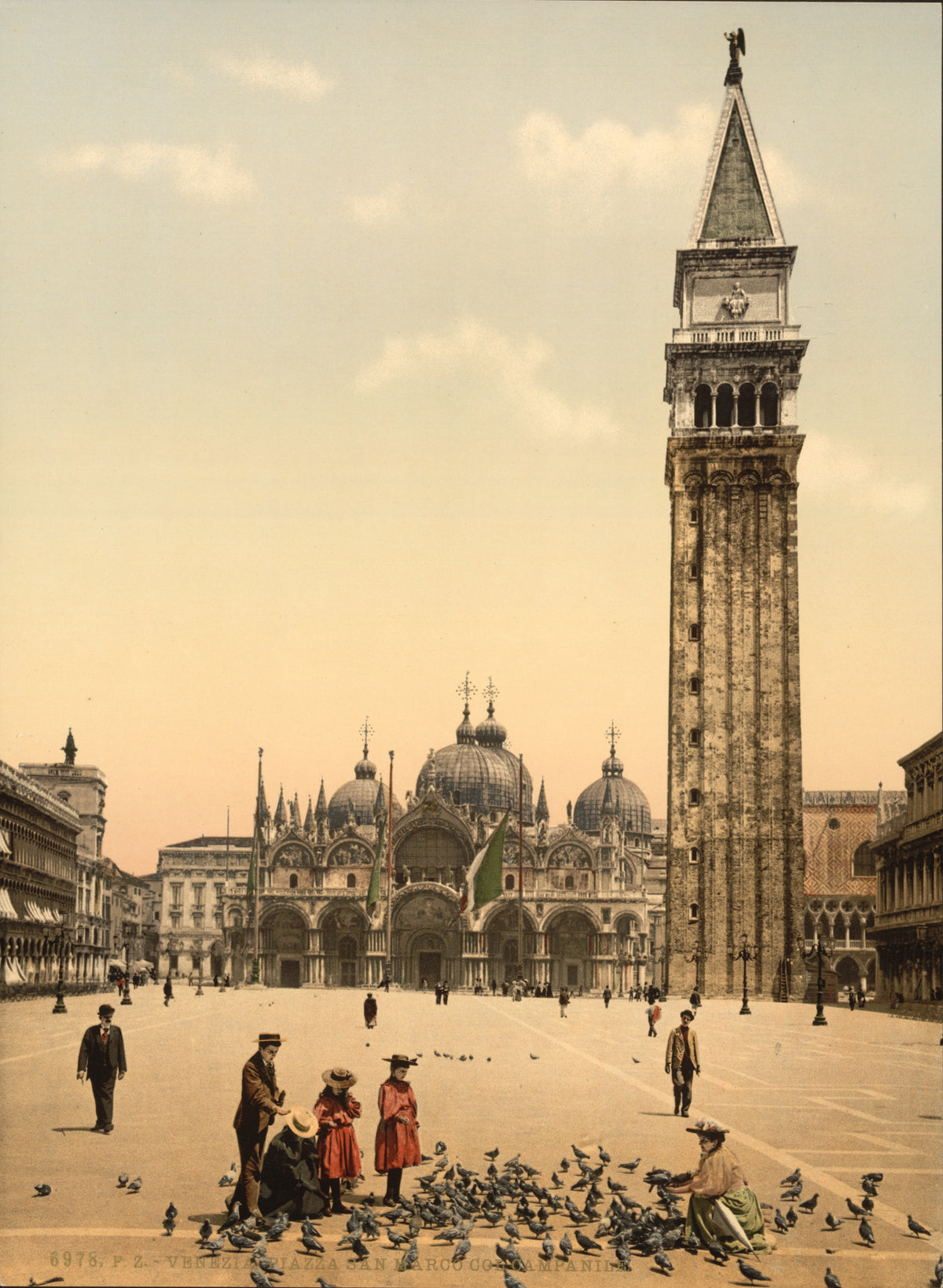 Visitors feed a flock of pigeons in St Mark’s Square beneath the basilica domes and towering campanile.