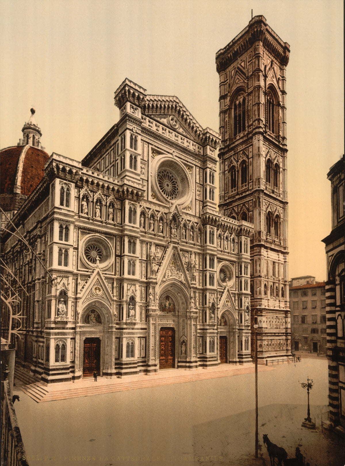 The richly patterned facade of Florence Cathedral and its tall bell tower overlook a quiet square in warm sepia tones.